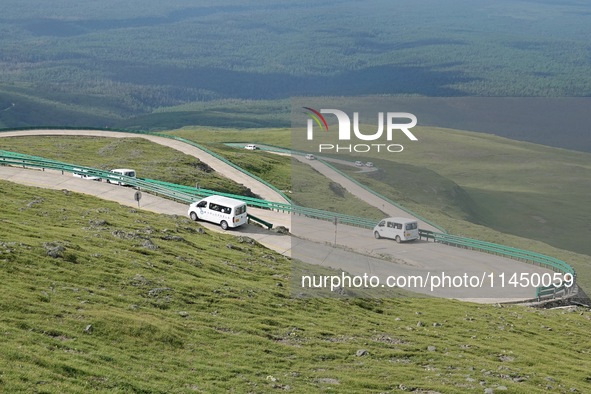 Tourists are taking a ferry bus to visit Tianchi Lake on the main peak of Changbai Mountain in Changbai Mountain, Northeast China's Jilin pr...