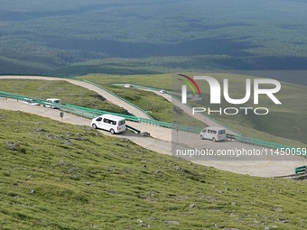 Tourists are taking a ferry bus to visit Tianchi Lake on the main peak of Changbai Mountain in Changbai Mountain, Northeast China's Jilin pr...