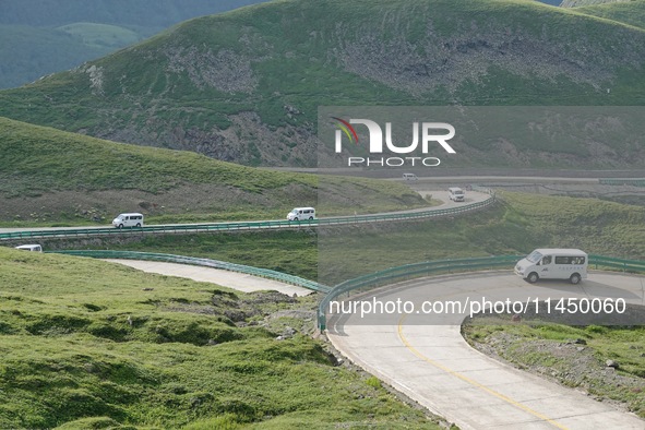 Tourists are taking a ferry bus to visit Tianchi Lake on the main peak of Changbai Mountain in Changbai Mountain, Northeast China's Jilin pr...