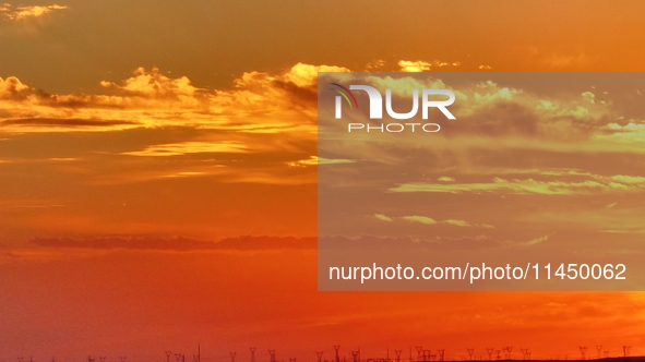 Colorful fire clouds are appearing on the Gobi Beach in Hami, Xinjiang province, China, on August 1, 2024. 