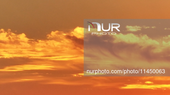 Colorful fire clouds are appearing on the Gobi Beach in Hami, Xinjiang province, China, on August 1, 2024. 