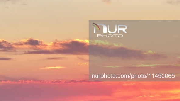 Colorful fire clouds are appearing on the Gobi Beach in Hami, Xinjiang province, China, on August 1, 2024. 