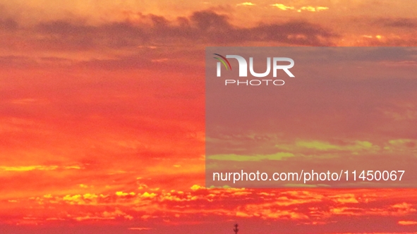 Colorful fire clouds are appearing on the Gobi Beach in Hami, Xinjiang province, China, on August 1, 2024. 