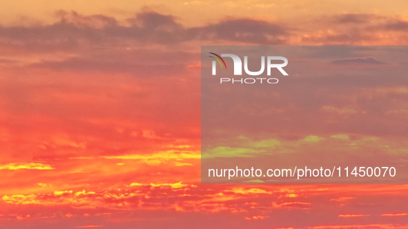 Colorful fire clouds are appearing on the Gobi Beach in Hami, Xinjiang province, China, on August 1, 2024. 