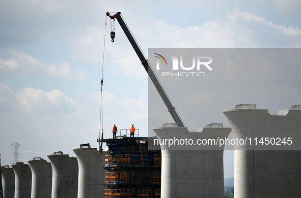 The Nanchang-Jiujiang Intercity Railway Xiu River Super Bridge is under construction in Jiujiang City, Jiangxi province, China, on August 1,...