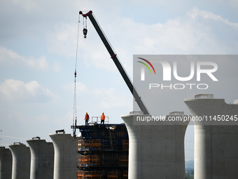 The Nanchang-Jiujiang Intercity Railway Xiu River Super Bridge is under construction in Jiujiang City, Jiangxi province, China, on August 1,...