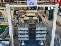 Workers are operating a machine to cast a sleeper at the Nanchang-Jiujiang Intercity Railway's Yongrepair sleeper yard in Jiujiang, China, o...