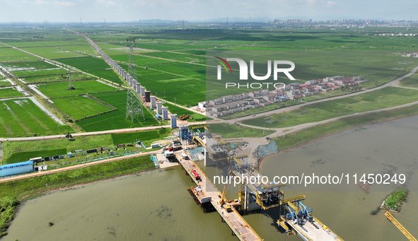 The Nanchang-Jiujiang Intercity Railway Xiu River Super Bridge is under construction in Jiujiang City, Jiangxi province, China, on August 1,...