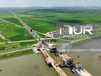 The Nanchang-Jiujiang Intercity Railway Xiu River Super Bridge is under construction in Jiujiang City, Jiangxi province, China, on August 1,...