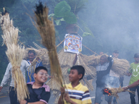 Children are carrying live hay straw as they are taking part in the immolation ceremony of demon deity Ghantakarna to veer off bad omens and...