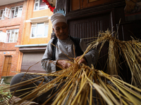 An elderly person is making an effigy of the demon deity Ghantakarna to immolate it, veering off the bad omens and warding off evil spirits...