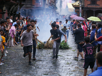 People are dragging the effigy of the demon deity Ghantakarna after setting it on fire to veer off bad omens and ward off evil spirits in Bh...