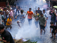 People are dragging the effigy of the demon deity Ghantakarna after setting it on fire to veer off bad omens and ward off evil spirits in Bh...