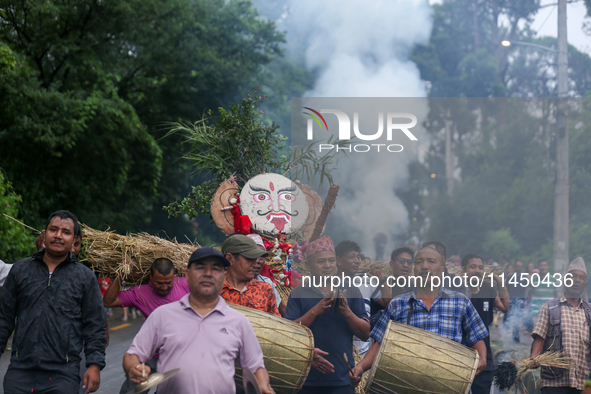 People are dragging the effigy of the demon deity Ghantakarna to set it on fire to veer off bad omens and ward off evil spirits in Bhaktapur...