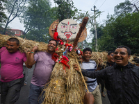 People are dragging the effigy of the demon deity Ghantakarna to set it on fire to veer off bad omens and ward off evil spirits in Bhaktapur...