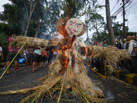 People are setting the effigy of the demon deity Ghantakarna on fire after dragging it down to a crossroad in Bhaktapur, Nepal, on August 2,...