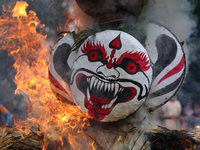 People are setting the effigy of the demon deity Ghantakarna on fire after dragging it down to a crossroad in Bhaktapur, Nepal, on August 2,...