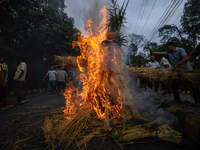 People are setting the effigy of the demon deity Ghantakarna on fire after dragging it down to a crossroad in Bhaktapur, Nepal, on August 2,...