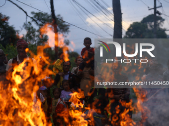 People are setting the effigy of the demon deity Ghantakarna on fire after dragging it down to a crossroad in Bhaktapur, Nepal, on August 2,...