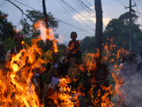 People are setting the effigy of the demon deity Ghantakarna on fire after dragging it down to a crossroad in Bhaktapur, Nepal, on August 2,...