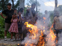 People are setting the effigy of the demon deity Ghantakarna on fire after dragging it down to a crossroad in Bhaktapur, Nepal, on August 2,...