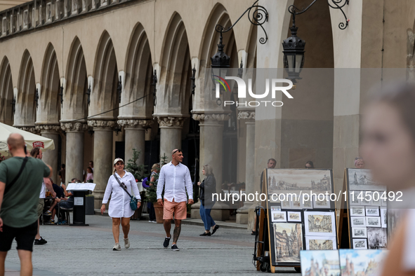 Visitors walk along stalls with hand made local souvenirs during a festival of UNESCO enlisted site of historical trade centre in Krakow, Po...