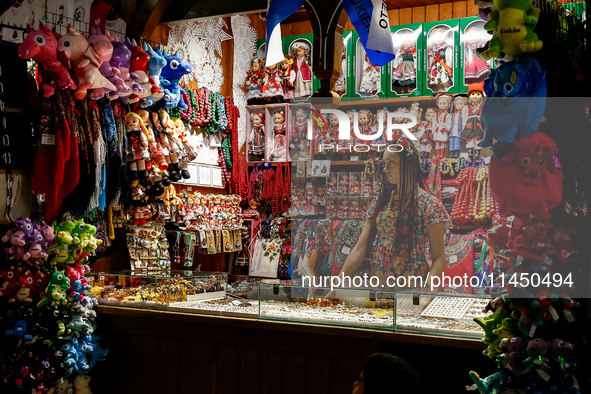 A seller stand in a stall with hand made local souvenirs during a festival of UNESCO enlisted site of historical trade centre in Krakow, Pol...