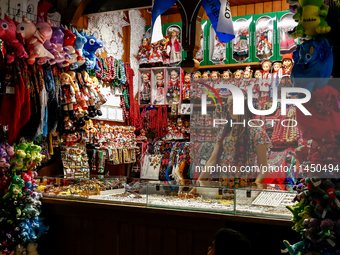 A seller stand in a stall with hand made local souvenirs during a festival of UNESCO enlisted site of historical trade centre in Krakow, Pol...