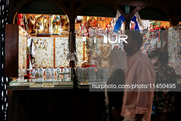 Visitors walk along stalls with hand made local souvenirs during a festival of UNESCO enlisted site of historical trade centre in Krakow, Po...