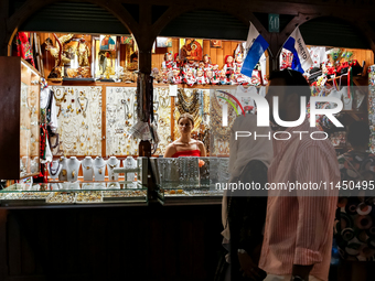 Visitors walk along stalls with hand made local souvenirs during a festival of UNESCO enlisted site of historical trade centre in Krakow, Po...