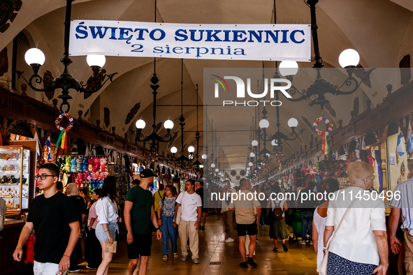 Visitors walk along stalls with hand made local souvenirs during a festival of UNESCO enlisted site of historical trade centre in Krakow, Po...