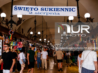 Visitors walk along stalls with hand made local souvenirs during a festival of UNESCO enlisted site of historical trade centre in Krakow, Po...