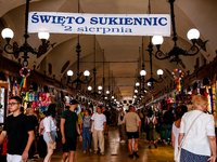 Visitors walk along stalls with hand made local souvenirs during a festival of UNESCO enlisted site of historical trade centre in Krakow, Po...