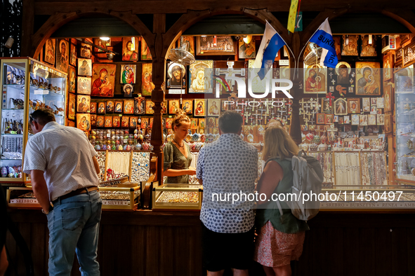 People stand in fron of a stall with hand made local souvenirs during a festival of UNESCO enlisted site of historical trade centre in Krako...