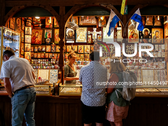 People stand in fron of a stall with hand made local souvenirs during a festival of UNESCO enlisted site of historical trade centre in Krako...