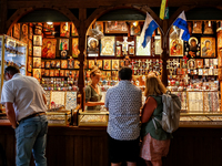 People stand in fron of a stall with hand made local souvenirs during a festival of UNESCO enlisted site of historical trade centre in Krako...