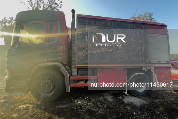 A Fire Brigade fire engine and another rescue vehicle are being seriously damaged by flames during operations to extinguish a large fire tha...