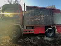 A Fire Brigade fire engine and another rescue vehicle are being seriously damaged by flames during operations to extinguish a large fire tha...