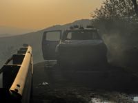 A Fire Brigade fire engine and another rescue vehicle are being seriously damaged by flames during operations to extinguish a large fire tha...