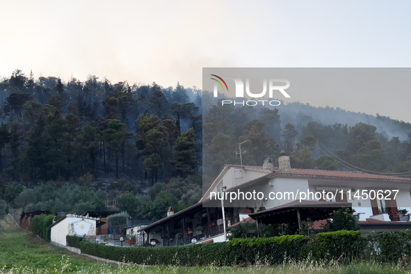 A Fire Brigade fire engine and another rescue vehicle are being seriously damaged by flames during operations to extinguish a large fire tha...