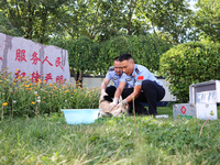 Police officers are looking at the injuries of a gose-throated antelope, a national second-class protected animal, in Altay, Xinjiang, China...