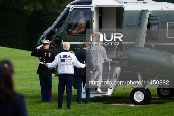 President Joe Biden gestures toward the Marine One pilot as boards with son Hunter Biden and sister Valerie Biden Owens at the White House,...