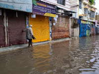 A person is walking on a water-logged street in Kolkata, India, on August 3, 2024. (