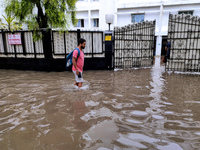 A person is walking on a water-logged street in Kolkata, India, on August 3, 2024. (