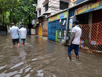 People are walking on a waterlogged street after heavy rains in Kolkata, India, on August 3, 2024. (