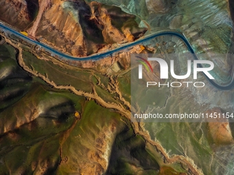 An aerial photo is showing 147 county roads among mountains in Changji Hui Autonomous Prefecture in Xinjiang province, China, on May 3, 2024...