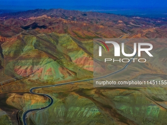 An aerial photo is showing 147 county roads among mountains in Changji Hui Autonomous Prefecture in Xinjiang province, China, on May 3, 2024...