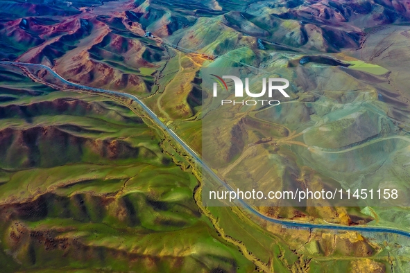 An aerial photo is showing 147 county roads among mountains in Changji Hui Autonomous Prefecture in Xinjiang province, China, on May 3, 2024...