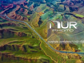 An aerial photo is showing 147 county roads among mountains in Changji Hui Autonomous Prefecture in Xinjiang province, China, on May 3, 2024...