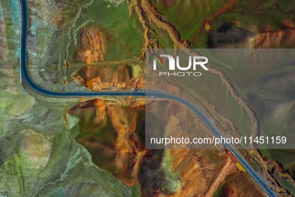 An aerial photo is showing 147 county roads among mountains in Changji Hui Autonomous Prefecture in Xinjiang province, China, on May 3, 2024...